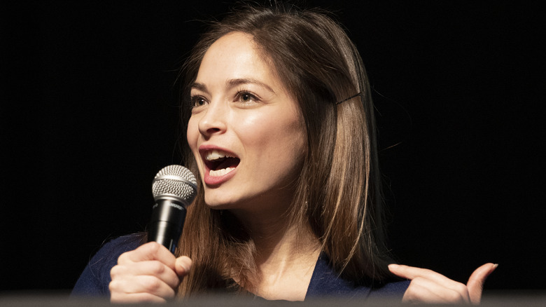 Kristin Kreuk speaking in a microphone