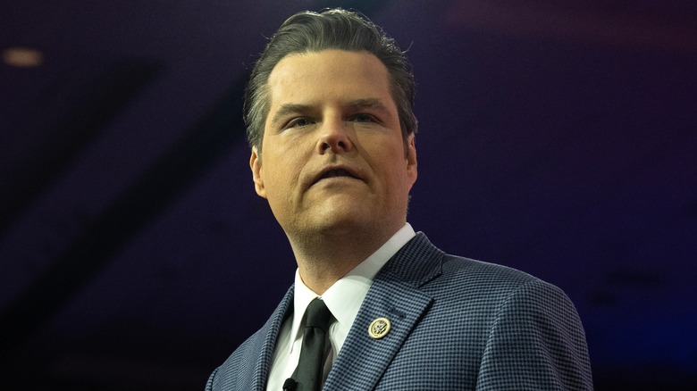 Matt Gaetz wearing a suit and frowning