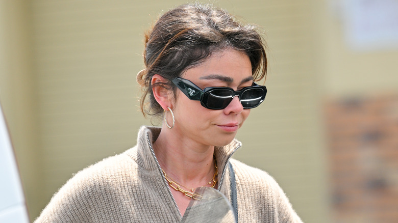 Sarah Hyland wearing sunglasses while walking