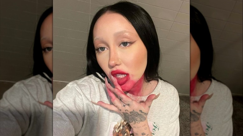 Noah Cyrus with red makeup smeared on face