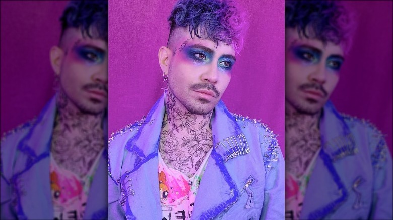 Jaremi Carey posing with blue and purple eye makeup