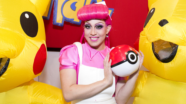 Phi Phi O'Hara smiling with Pokemon merch