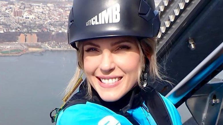 Tessa Carlson climbing a building