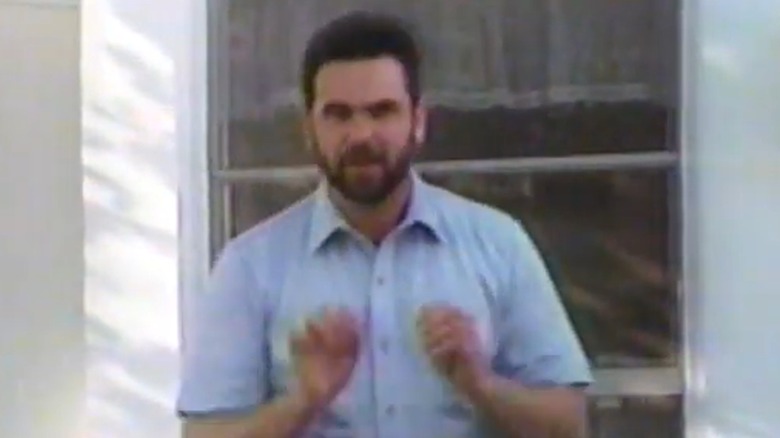 Billy Mays in blue shirt hands up