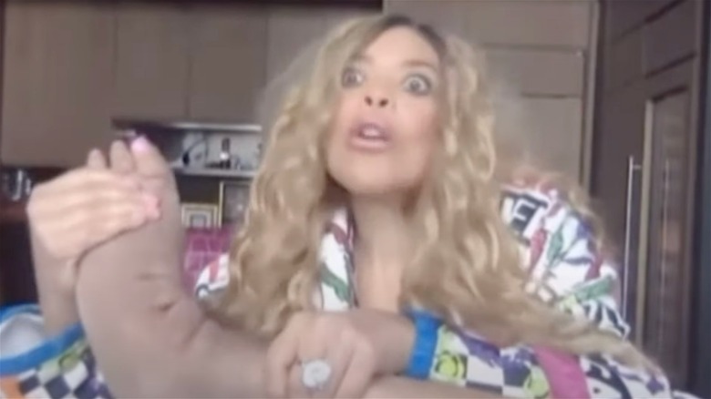 Wendy Williams holding swollen foot