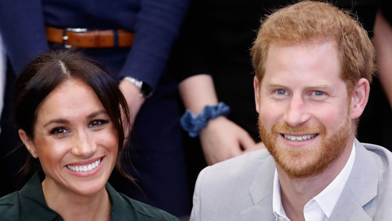 Meghan Markle and Prince Harry smiling for the camera