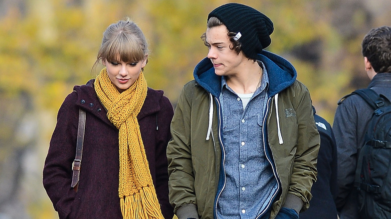 Taylor Swift and Harry Styles walking in winter-wear