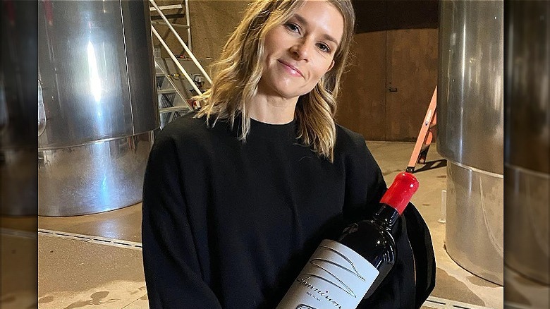 Danica Patrick holding bottle of wine