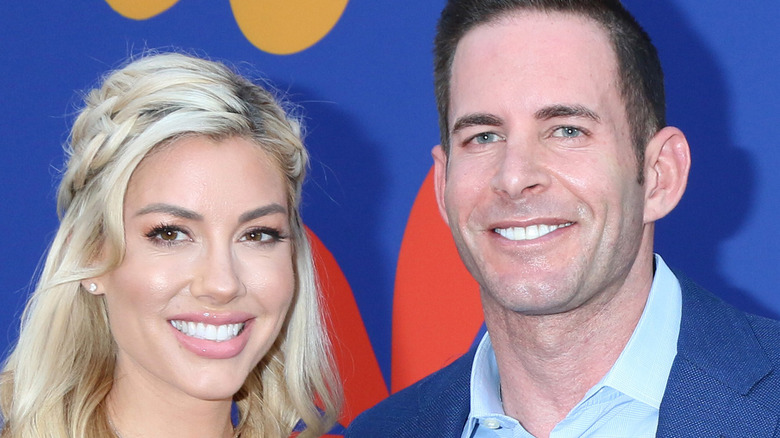 Heather Rae Young and Tarek El Moussa smiling on red carpet