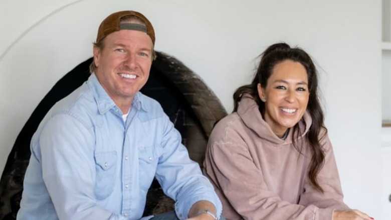 Chip and Joanna smiling while sitting