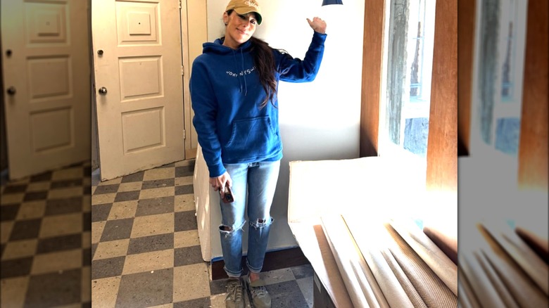 Joanna Gaines wearing a hoodie and baseball cap