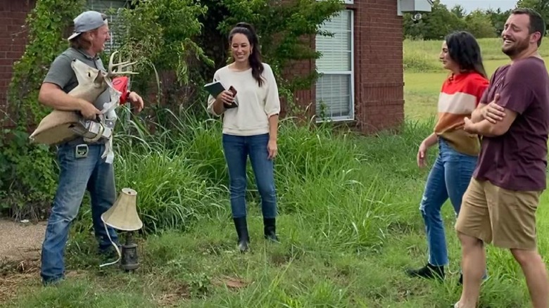 Fixer Upper contestants and cast standing in grass