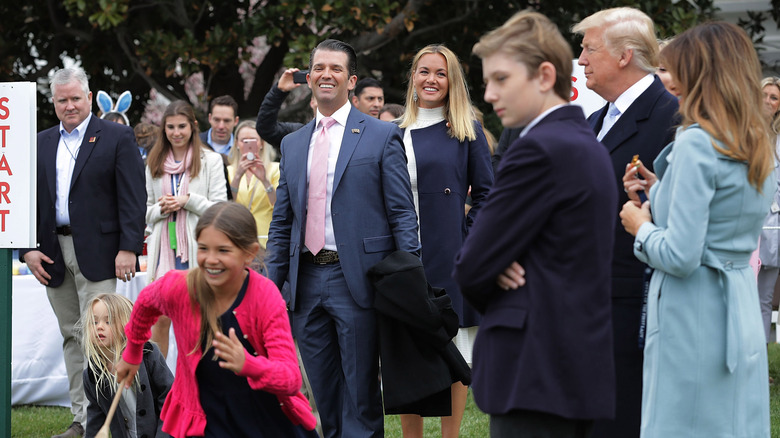 Barron Trump standing with family