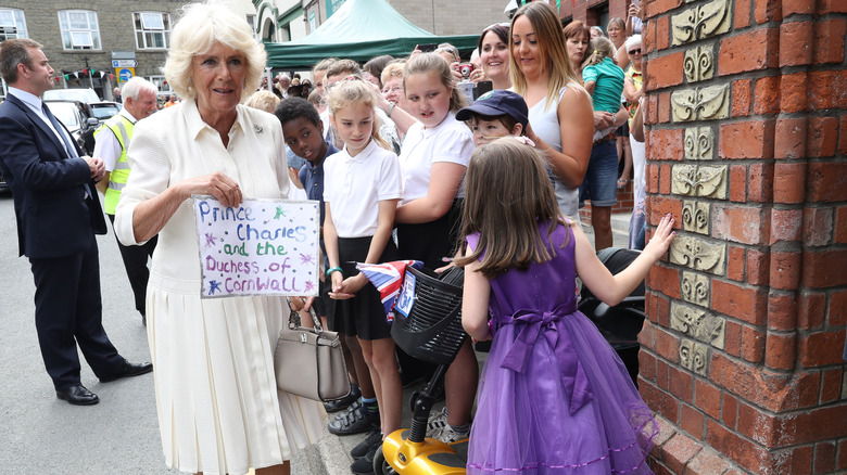 Camilla Parker Bowles holding up a sign