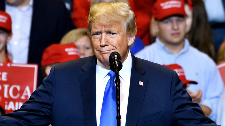  Donald Trump gestures a smirk and a smile at a campaign rally 2018 