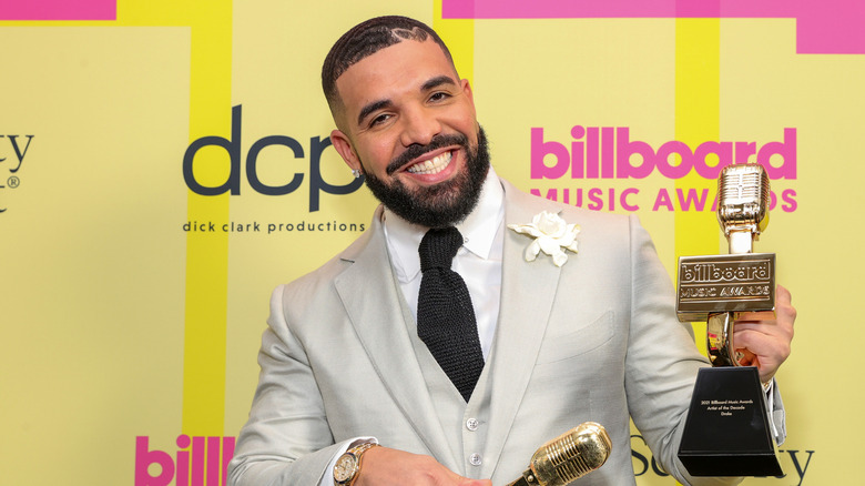 Drake holding awards