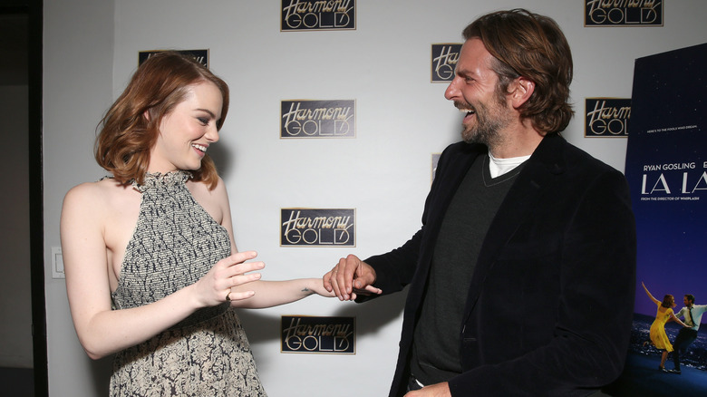 Emma Stone and Bradley Cooper laughing