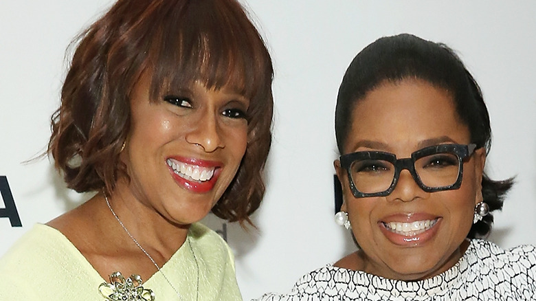 Gayle King and Oprah Winfrey smiling