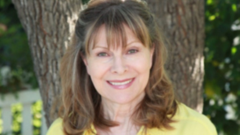 Jenny Jones smiling in yellow shirt