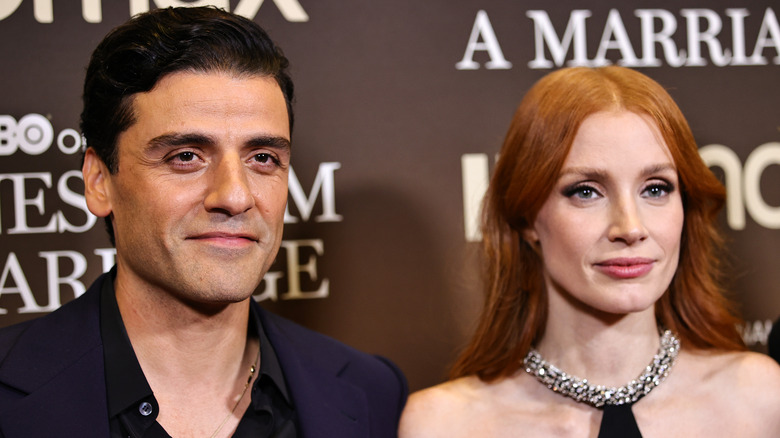 Oscar Isaac and Jessica Chastain smiling on the red carpetat an event 