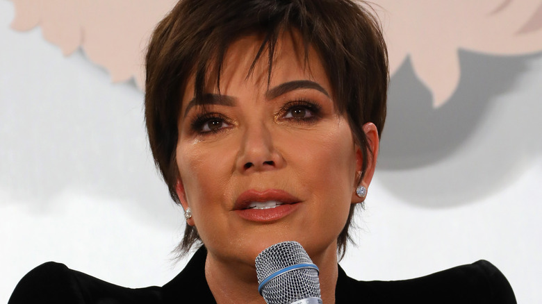 Kris Jenner speaking into a microphone