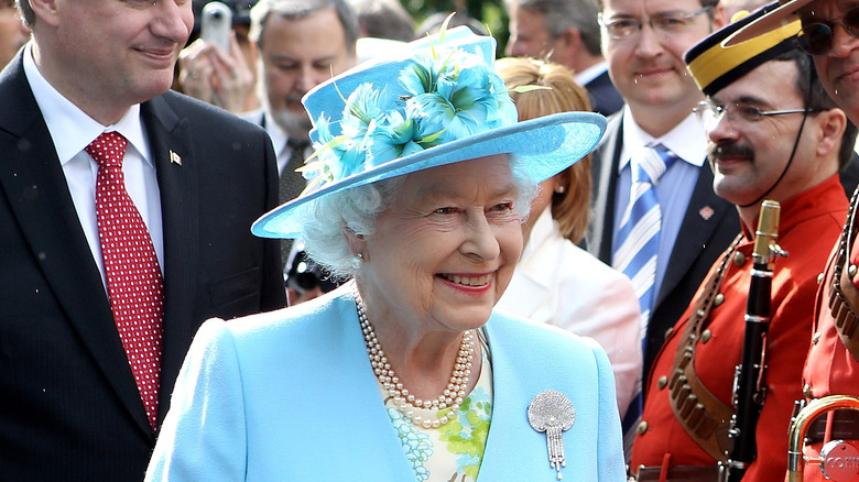 Queen Elizabeth II greeting band members