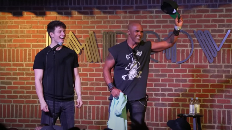 Shemar Moore raising hat beside Matt Rife