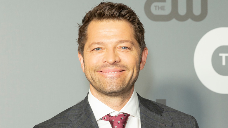 Misha Collins smiles on red carpet