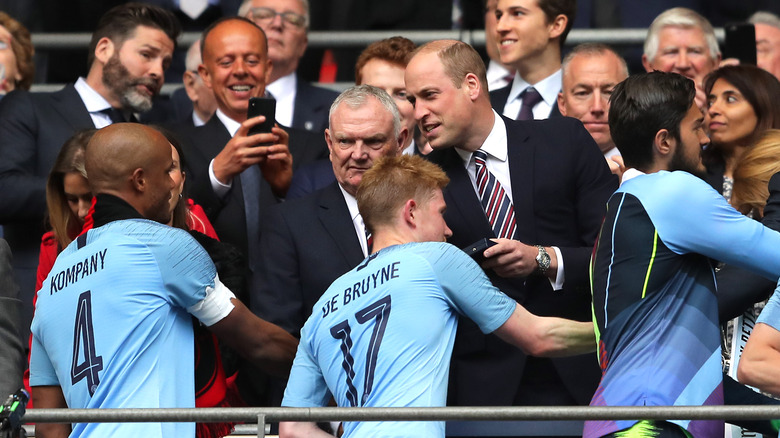 Prince William greeting a sports team