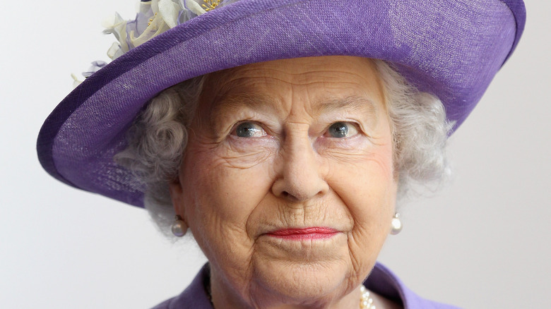 Queen Elizabeth purses her lips during a photo call