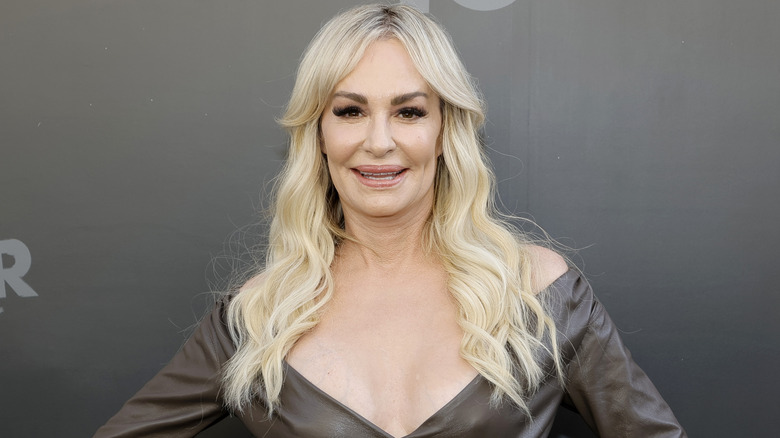 Taylor Armstrong long platinum curled hair grinning