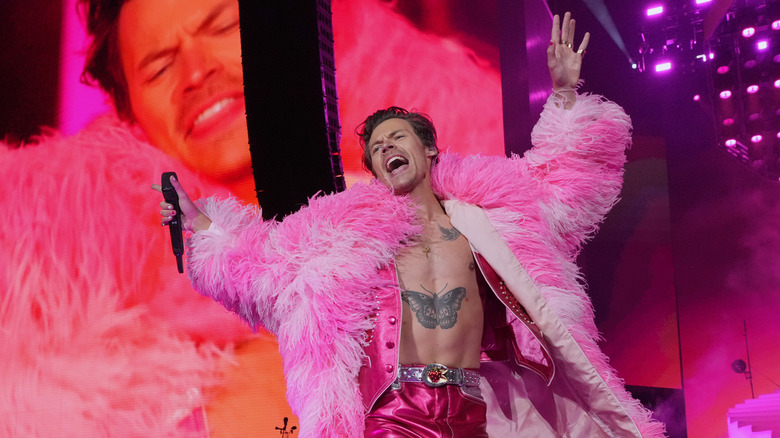 Harry Styles performing in pink boa at Coachella 2022