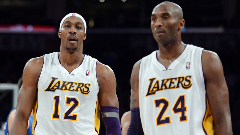 Dwight Howard and Kobe Bryant, posing on the baskeball court