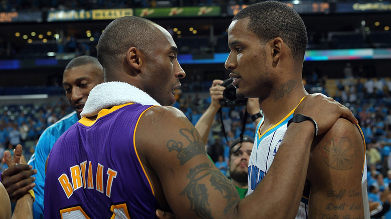 Kobe Bryant, holding Trevor Ariza by the shoulder