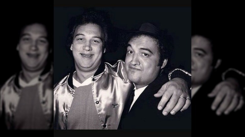 Jim Belushi  with his arm around John Belushi's shoulders.