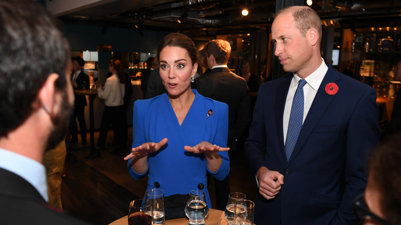 Kate Middleton speaking while Prince William watches