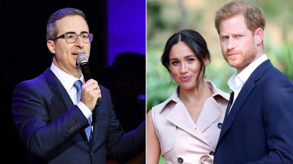 John Oliver speaking on stage, Meghan Markle and Prince Harry looking off-camera