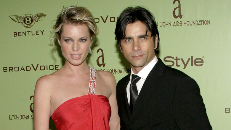 Rebecca Romijn and John Stamos at an event