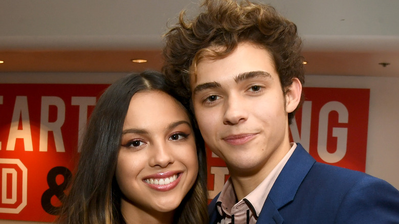 Olivia Rodrigo and Joshua Bassett smiling for cameras