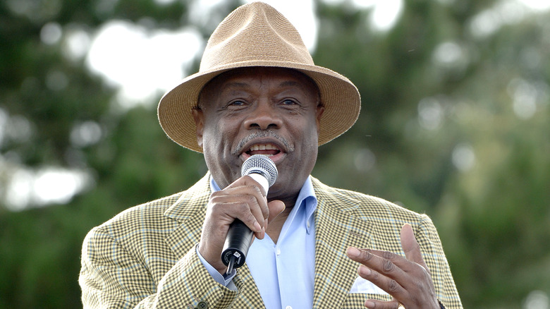 Willie Brown holding a mic