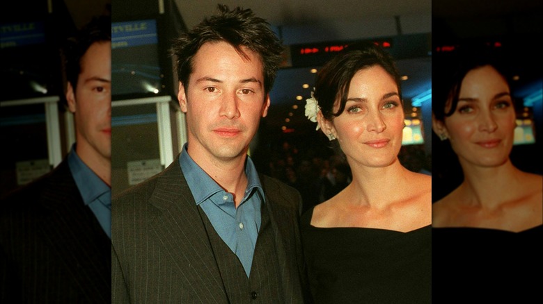 Keanu Reeves and Carrie-Anne Moss posing