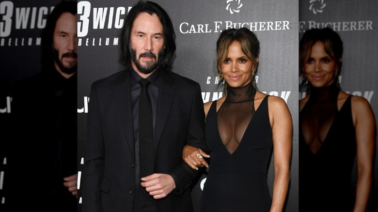 Keanu Reeves and Halle Berry linking arms