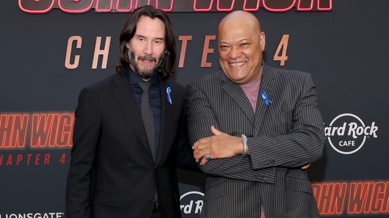 Keanu Reeves and Laurence Fishburne smiling