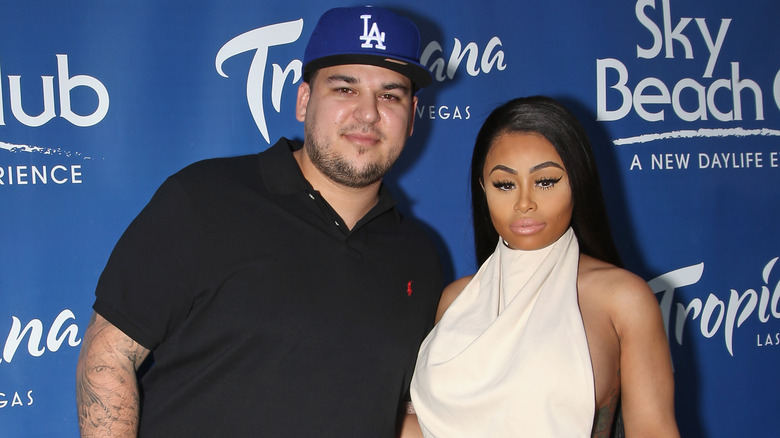 Blac Chyna and Rob Kardashian stand at an event