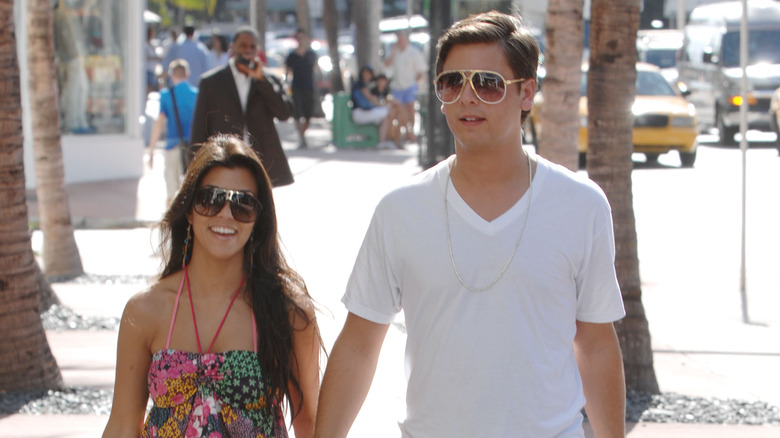 Kourtney Kardashian, Scott Disick, holding hands, 2007, in Miami, both wearing sunglasses