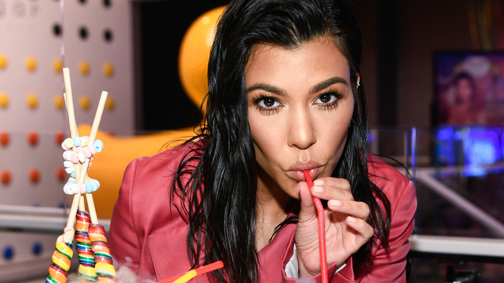 Kourtney Kardashian sipping a drink