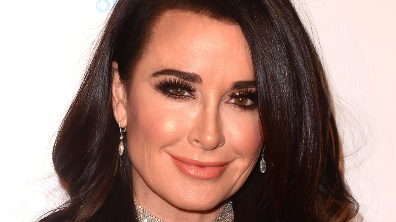 Kyle Richards smiles in a black gown