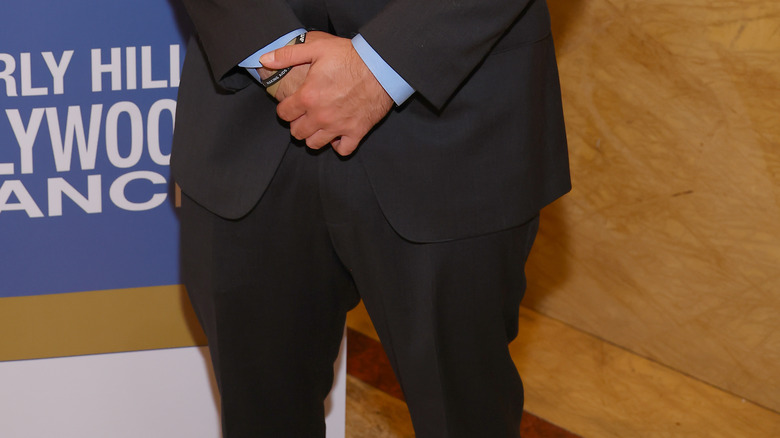 Prince Jackson wearing a black jacket, blue shirt, and black tie