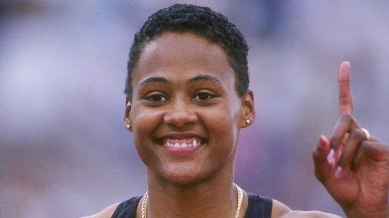 Marion Jones smiling and holding up her index finger