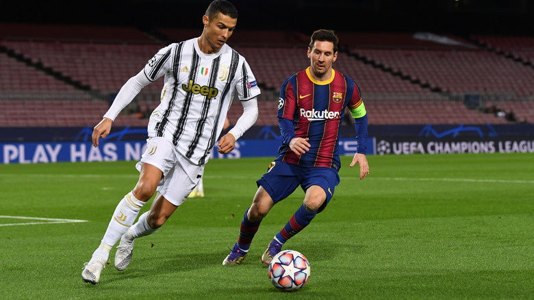 Cristiano Ronaldo and Lionel Messi playing soccer